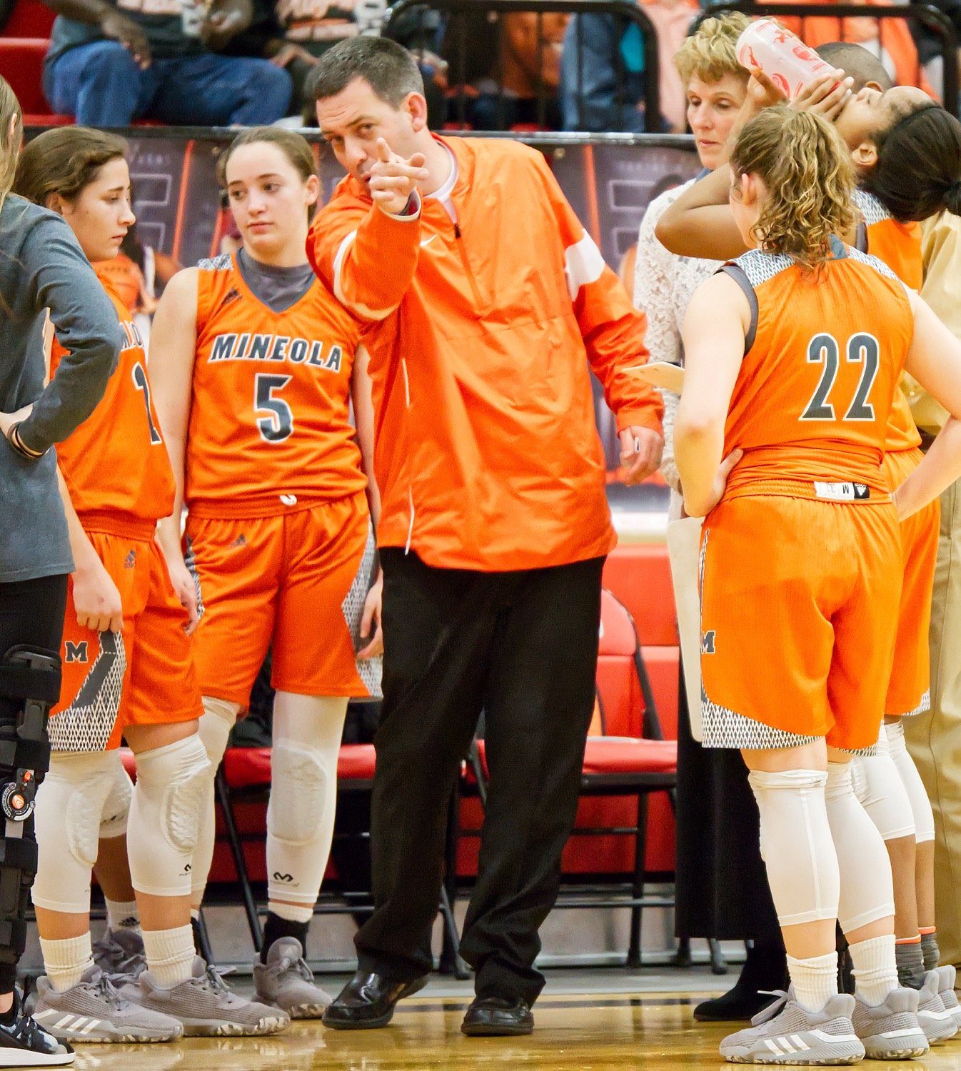Coach Brad Gibson makes a point to the huddled Ladyjackets during a timeout.